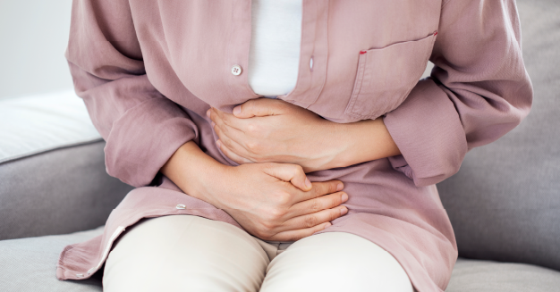 woman holding her stomach in pain