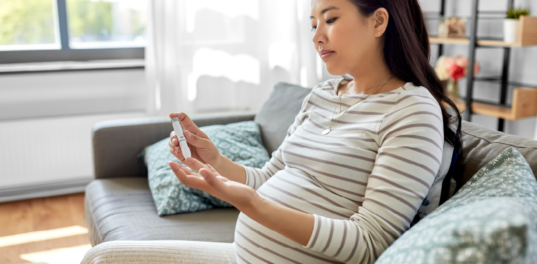 Pregnant woman doing a glucose test at home